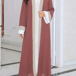 Une robe à manches longues et ample pour le Ramadan, avec des couleurs contrastées élégantes et une coupe moulante, idéale pour la mode féminine.